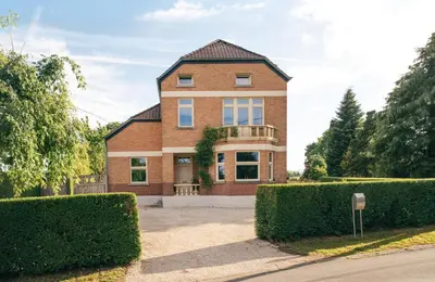 a brick house with bushes in front of it at Villa Paulette