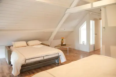 a bedroom with two beds in a attic at Villa Paulette