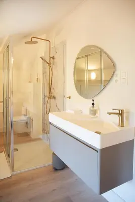 a white bathroom with a sink and a mirror at Villa Paulette