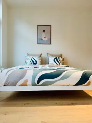 a bedroom with a large bed with a colorful blanket at The 9th Street Residence in Brussels