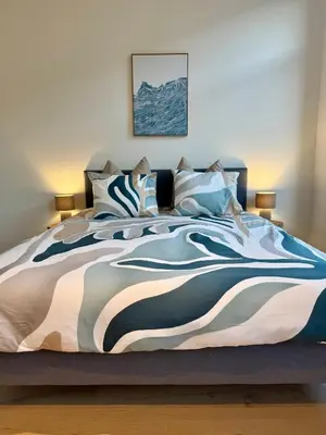 a bedroom with a large bed with a colorful blanket at The 9th Street Residence in Brussels