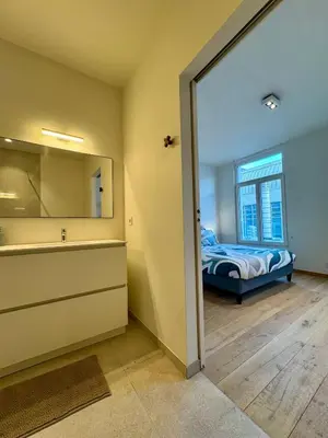 a bedroom with a bed and a large mirror at The 9th Street Residence in Brussels