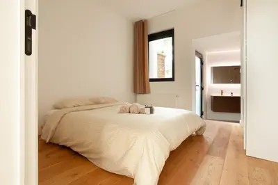 a bedroom with a bed with two pillows on it at Stylish 1BR Apartment near Zuid in Antwerp