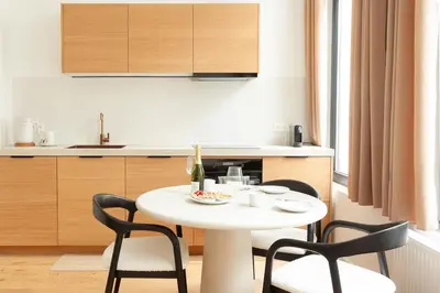 a kitchen with a white table and two chairs at Stylish 1BR Apartment near Zuid in Antwerp