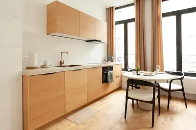 a kitchen with a table and a table and chairs at Stylish 1BR Apartment near Zuid in Antwerp