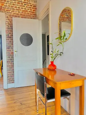 a dining room table with a vase on top of it at Big cosy Family Duplex near Grande Place in Brussels
