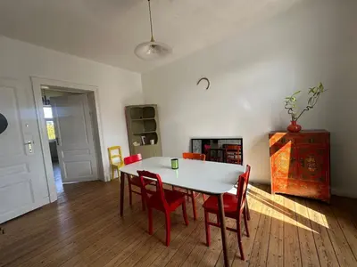 a dining room with a white table and red chairs at Big cosy Family Duplex near Grande Place in Brussels