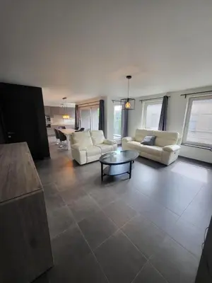 a living room with couches and a coffee table at Ruim appartement met terras in Ghent