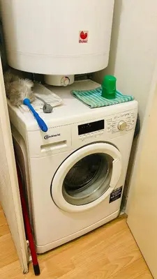 a washing machine with a computer on top of it at Modern Studio with Terrace Woluwe-Saint-Lambert in Brussels