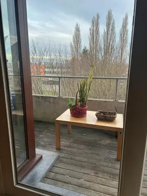 a balcony with a wooden bench and a window at Modern Studio with Terrace Woluwe-Saint-Lambert in Brussels