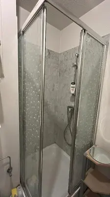 a shower with a glass door in a bathroom at Modern Studio with Terrace Woluwe-Saint-Lambert in Brussels