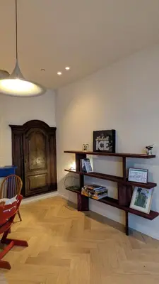 a living room with a book shelf and a wooden floor at Geldmunt 37 in Ghent