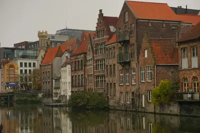 a group of buildings next to a river at Geldmunt 37 in Ghent