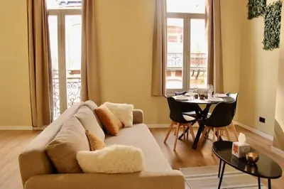 a living room with a couch and a table at Nice one-bedroom apartment in Brussels