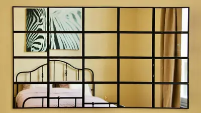 a view of a room with a mirror and a crib at Nice one-bedroom apartment in Brussels