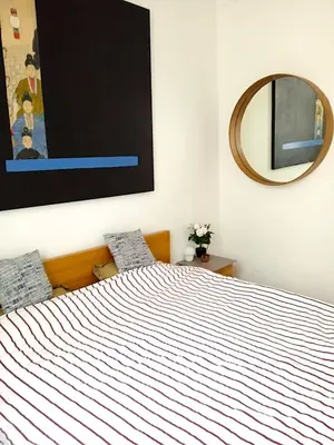a bedroom with a large bed with a large mirror at Nest in Brussels in Brussels