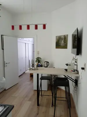 a kitchen with a table and chairs in a room at Nest in Brussels in Brussels