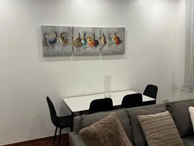 a living room with a couch and a table at A soothing nest in Brussels