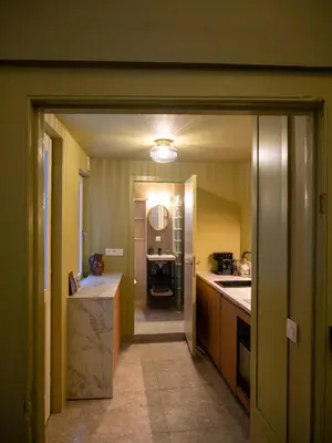 a kitchen with yellow walls and a hallway with a counter at Spacious home in the heart of Antwerp! in Antwerp