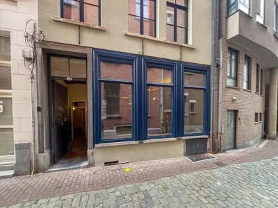 a building with blue windows on a city street at Spacious home in the heart of Antwerp! in Antwerp