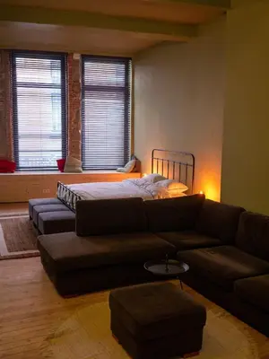 a living room with a couch and a bed at Spacious home in the heart of Antwerp! in Antwerp