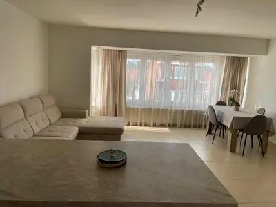 a living room with a couch and a table at Bright & Peaceful Appartment in Koningslo in Vilvoorde