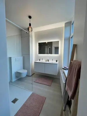 a bathroom with a sink and a toilet and a mirror at Holiday Home La Petite Maison in Ghent