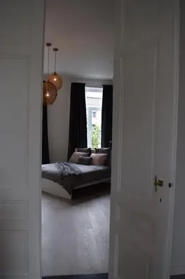 a bedroom with a bed and a large window at Holiday Home La Petite Maison in Ghent