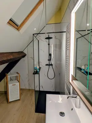 a bathroom with a glass shower and a sink at Duplex 3BR apartment near supermarkets & metro in Brussels