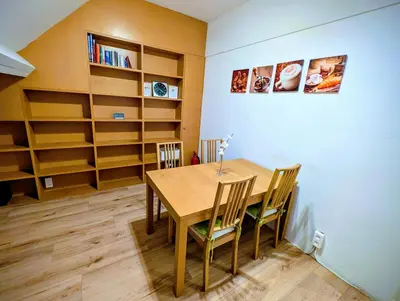 a dining room with a table and chairs and shelves at Duplex 3BR apartment near supermarkets & metro in Brussels