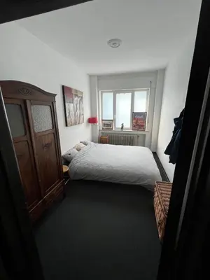 a bedroom with a bed and a window at Ground floor in Brussels