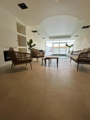 a living room with several chairs and a table at Fiori private wellness en hotel in Lier