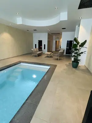 a large living room with a swimming pool at Fiori private wellness en hotel in Lier