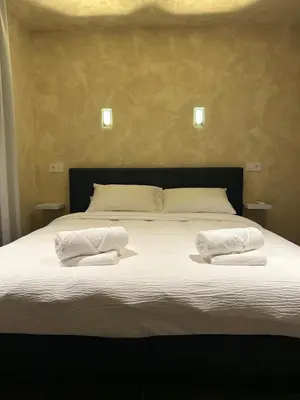 a bed with two white towels on top of it at Fiori private wellness en hotel in Lier