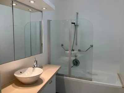 a bathroom with a sink and a glass shower at RS10 One-Bedroom Apartment in Turnhout