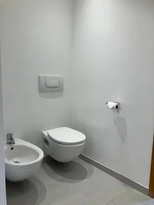 a white bathroom with a toilet and a sink at RS10 One-Bedroom Apartment in Turnhout