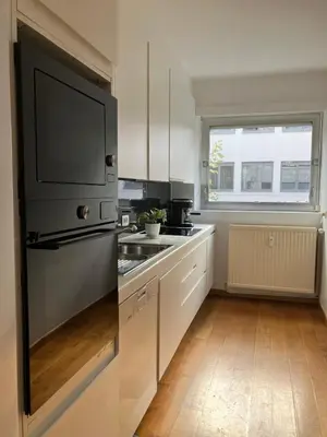 a kitchen with a black refrigerator and a sink at RS10 One-Bedroom Apartment in Turnhout