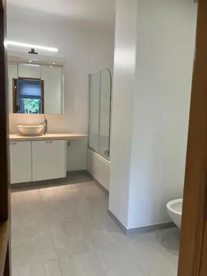 a white bathroom with a sink and a toilet at RS10 One-Bedroom Apartment in Turnhout