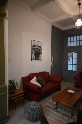 a living room with a red couch and a table at Cozy Apartment in Brussels of 75 m² in Brussels