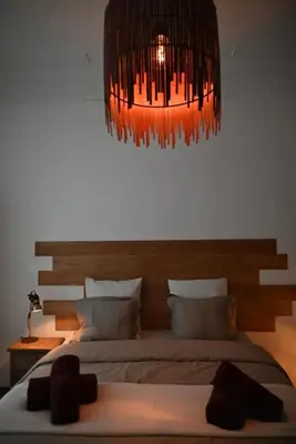a bedroom with a large bed and a chandelier at Cozy Apartment in Brussels of 75 m² in Brussels