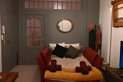 a bedroom with a bed with a couch and a mirror at Cozy Apartment in Brussels of 75 m² in Brussels