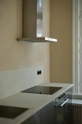 a kitchen with a white counter top and a stove at Stylish apartment in 16th century city palace! in Antwerp