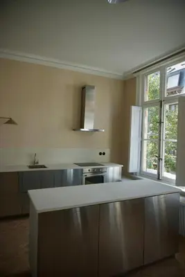 a kitchen with a white counter top in a room at Stylish apartment in 16th century city palace! in Antwerp