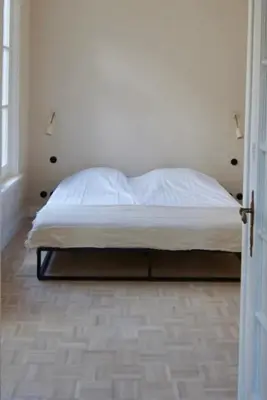 a bed in a room with a white mattress at Stylish apartment in 16th century city palace! in Antwerp