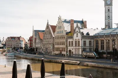 a city with a river and buildings and a clock tower at La Petite Foret Stylish City Apartment Ghent in Ghent