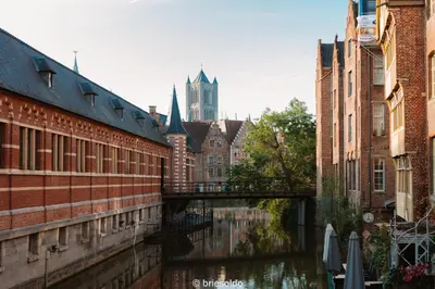 a bridge over a river in a city with buildings at La Petite Foret Stylish City Apartment Ghent in Ghent
