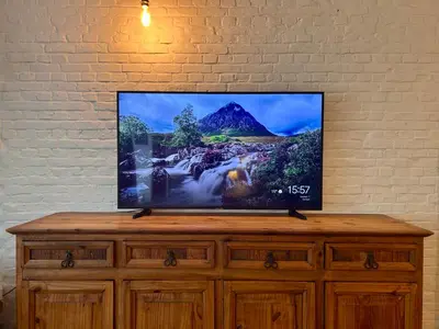 a flat screen tv sitting on top of a wooden dresser at The Vintage Warehouse Room in Antwerp
