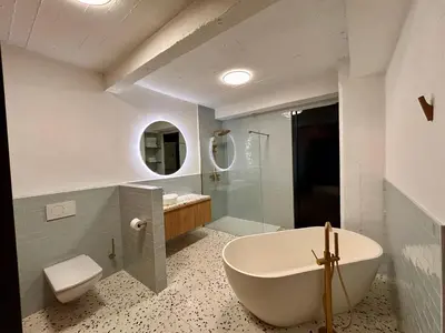 a bathroom with a tub and a toilet and a sink at The Vintage Warehouse Room in Antwerp