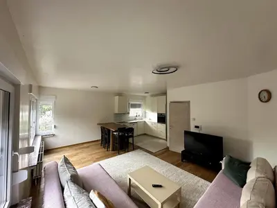 a living room with a couch and a table at Cozy&Spacious apartment with garden in Antwerp
