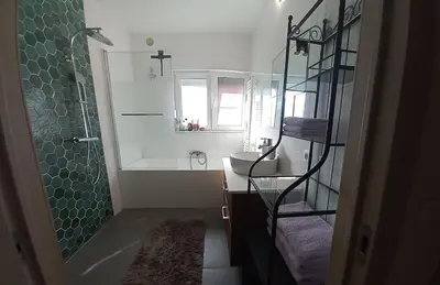 a bathroom with a tub and a sink and a shower at Cozy&Spacious apartment with garden in Antwerp